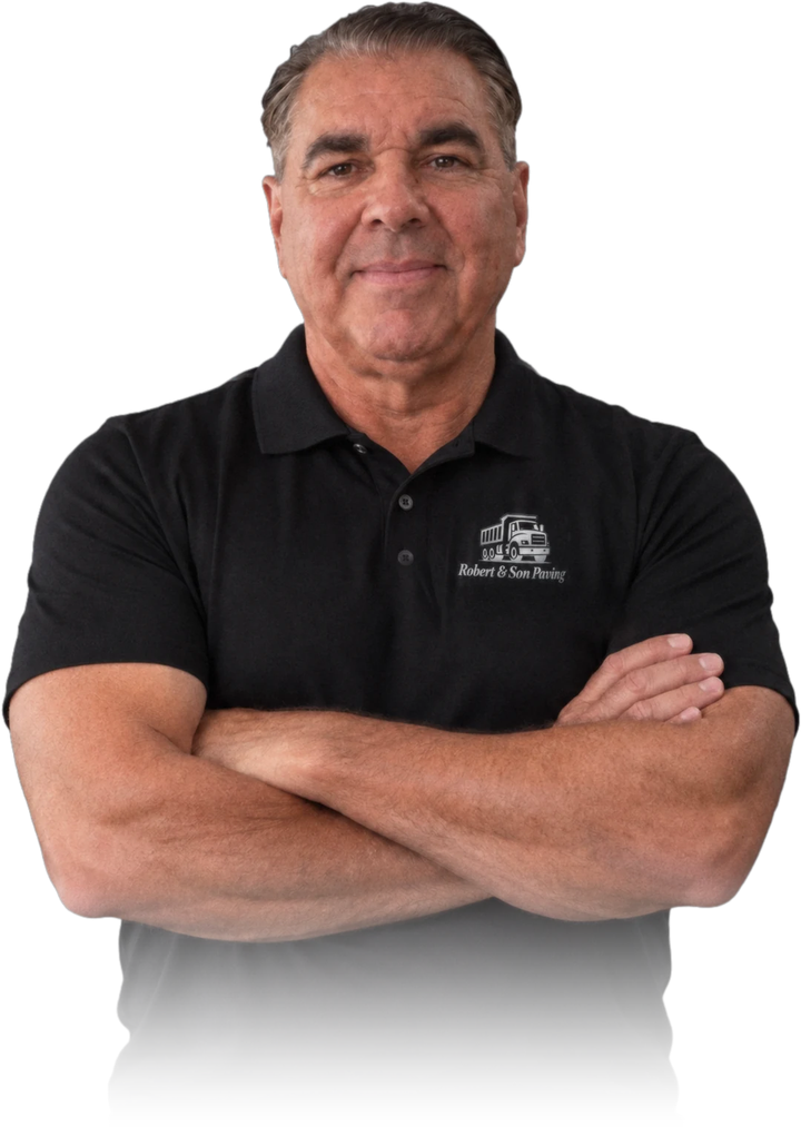 Bob Harrison, owner of Robert and Son Paving, arms folded