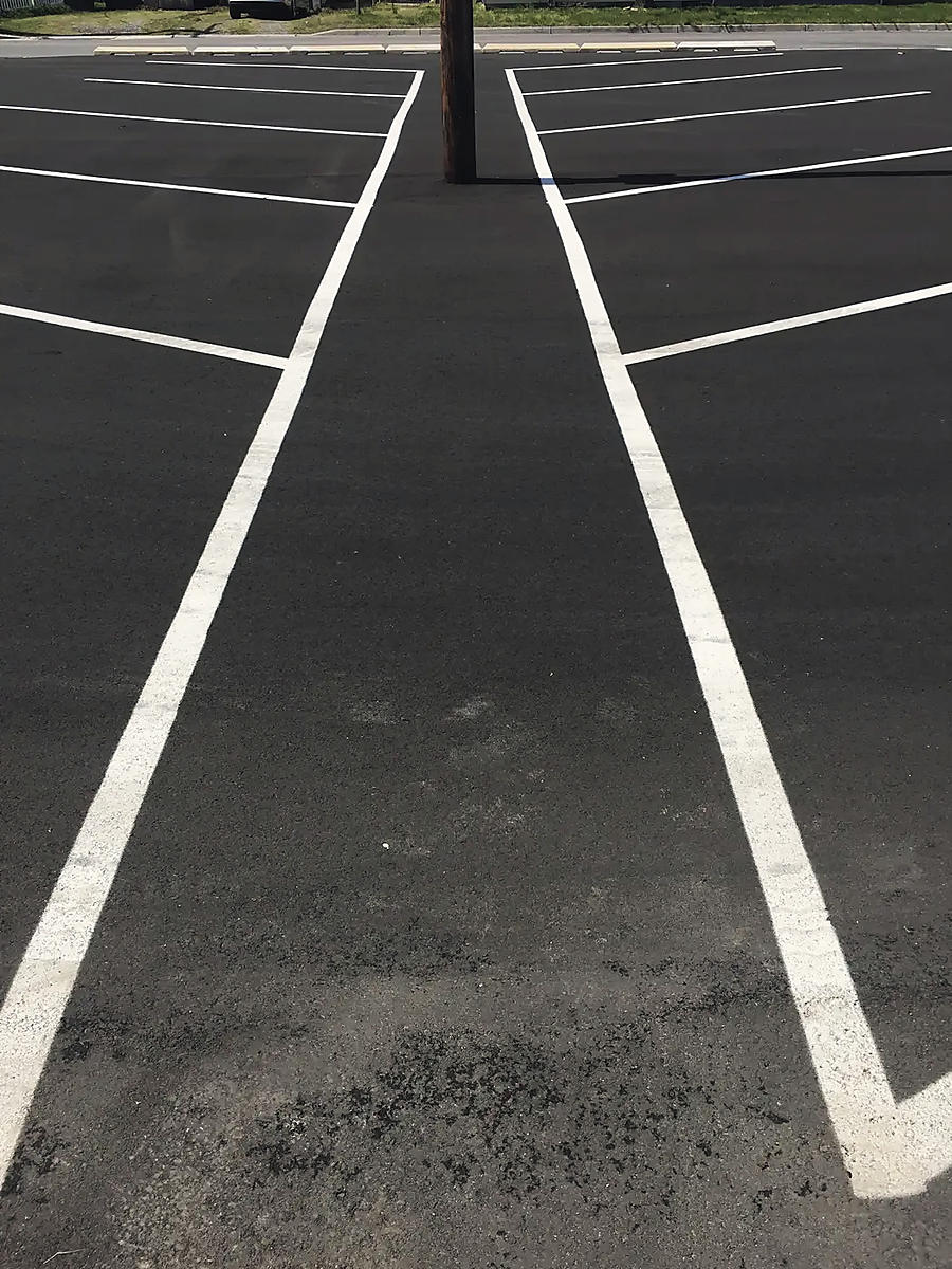 Crisp white bay lines on new asphalt