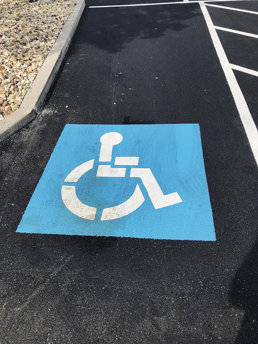 A blue accessible parking bay, freshly painted