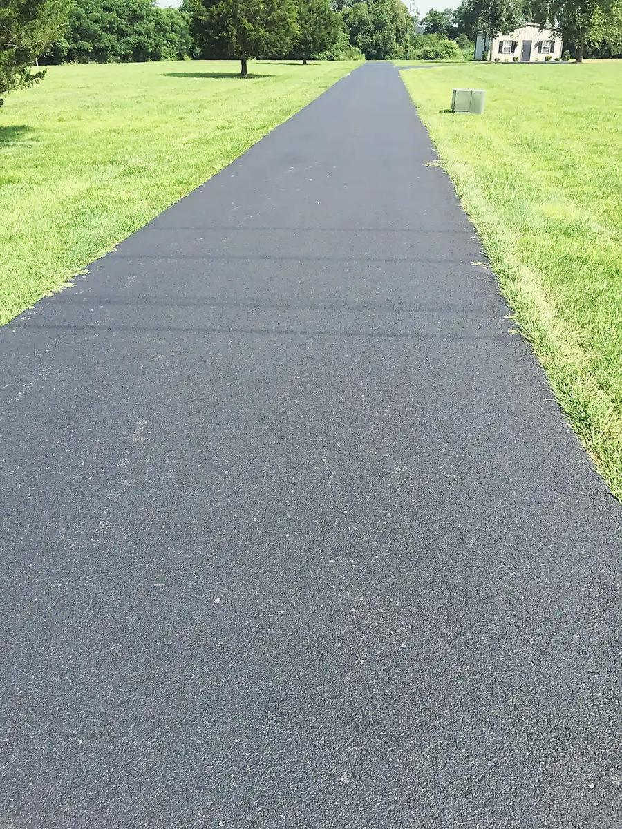 Long approach to a white farmhouse