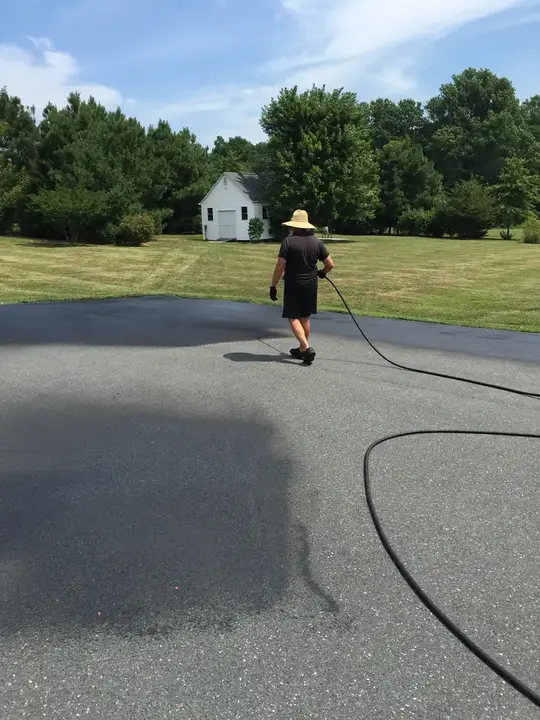 Sealcoating Spraying Sealer Across A Wide Drive Federalsburg Md